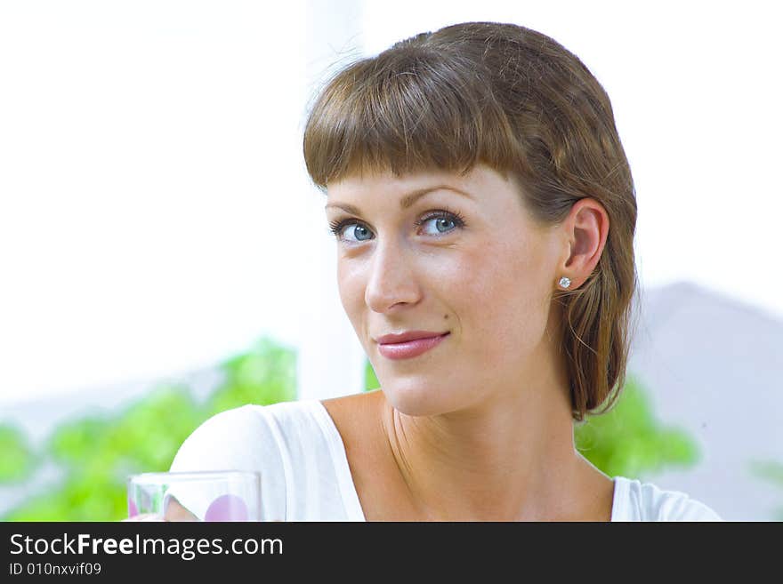 High-key portrait of young blue eyed woman on color back