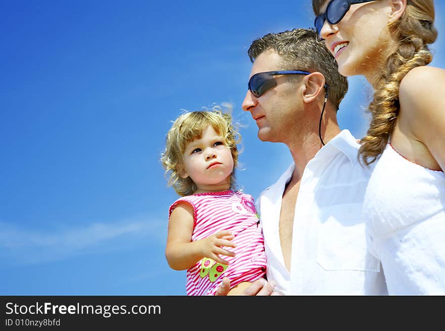 View of young family hanging out in summer environment. View of young family hanging out in summer environment.