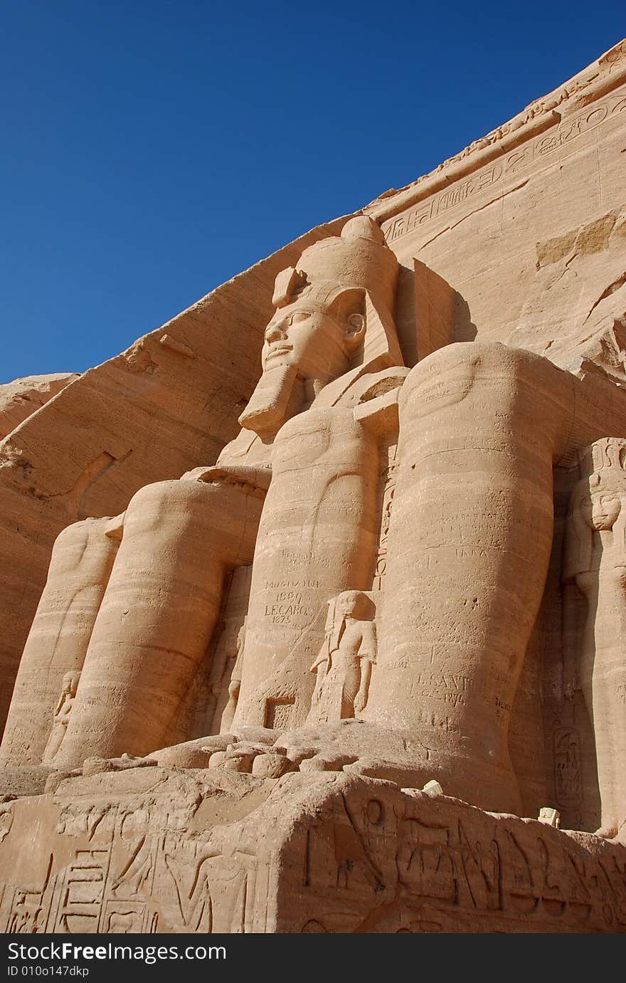 Two of the colossal statues of Rameses II seen from beneath, emphasizing the huge size, Abu Simbel, Egypt. Two of the colossal statues of Rameses II seen from beneath, emphasizing the huge size, Abu Simbel, Egypt