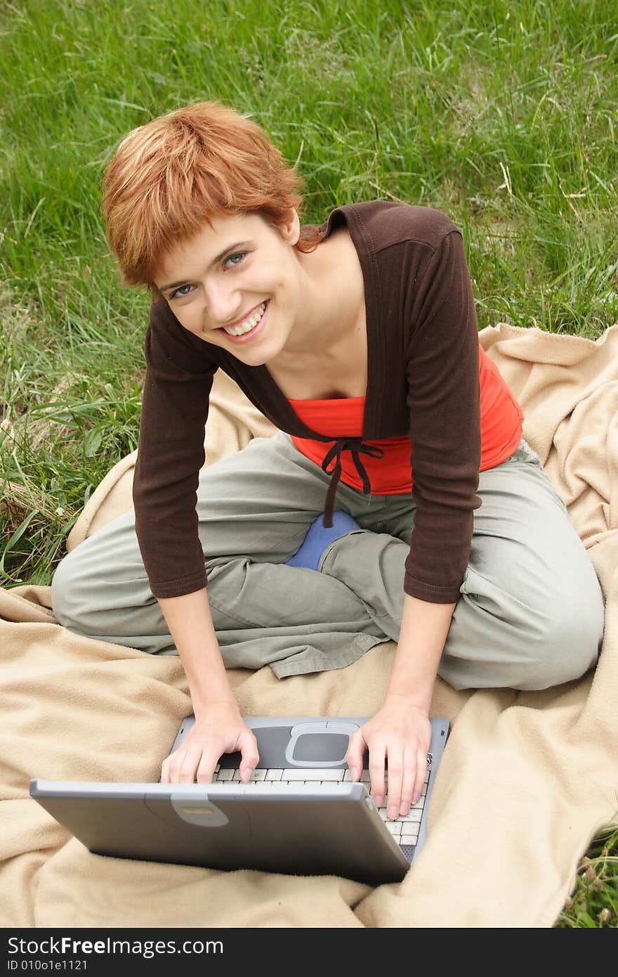 Young girl working on laptop and smiling