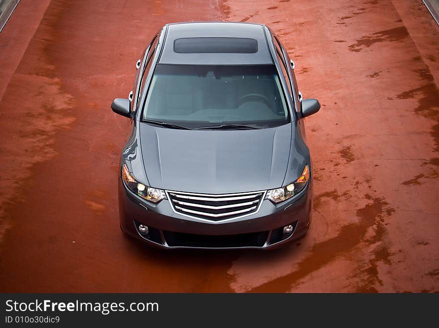 Business sedan front view on a red asphalt. Business sedan front view on a red asphalt.