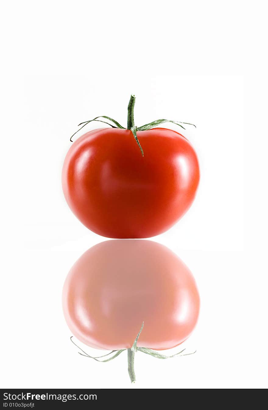 Close up view of nice red fresh tomato on white back