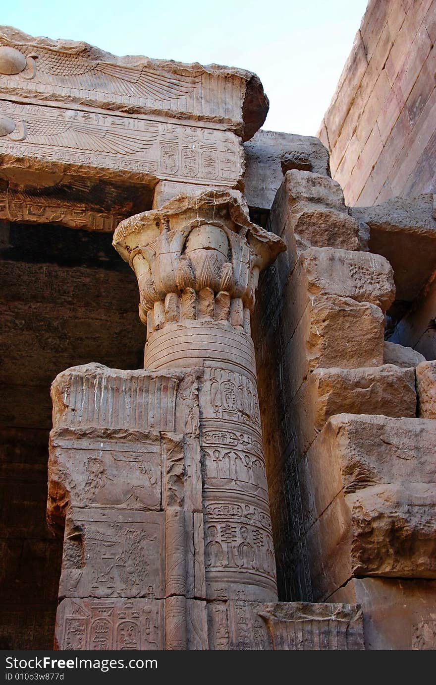 Ornate column and fragment of a wall in the temple of Edfu, Egypt. Existing light, lots of shadows. Ornate column and fragment of a wall in the temple of Edfu, Egypt. Existing light, lots of shadows.