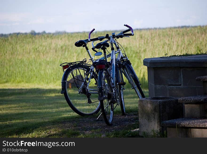 Two bicycles on field background