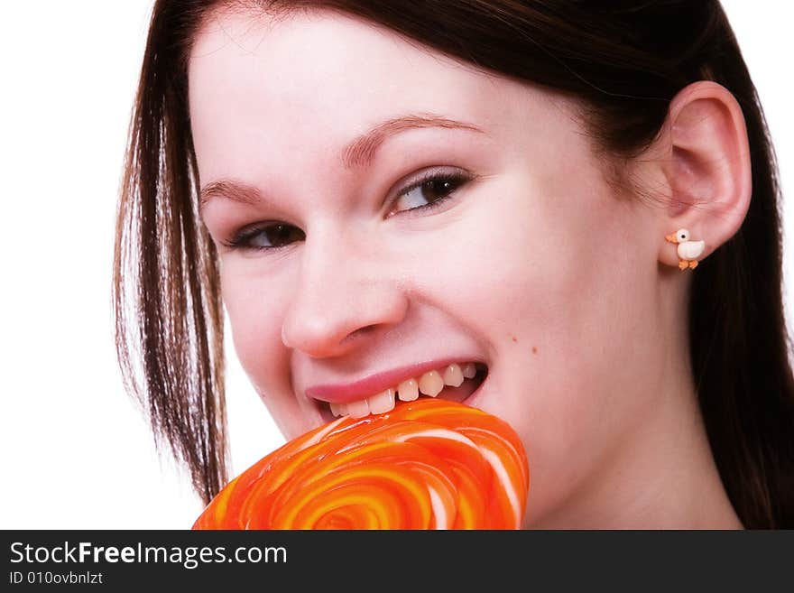 Portrait of a young teen enjoying a giant orange lollypop. Portrait of a young teen enjoying a giant orange lollypop.