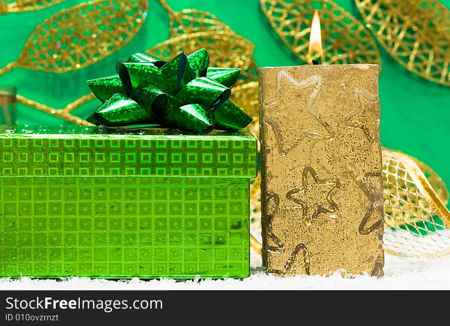 Festive candle with green present. Festive candle with green present