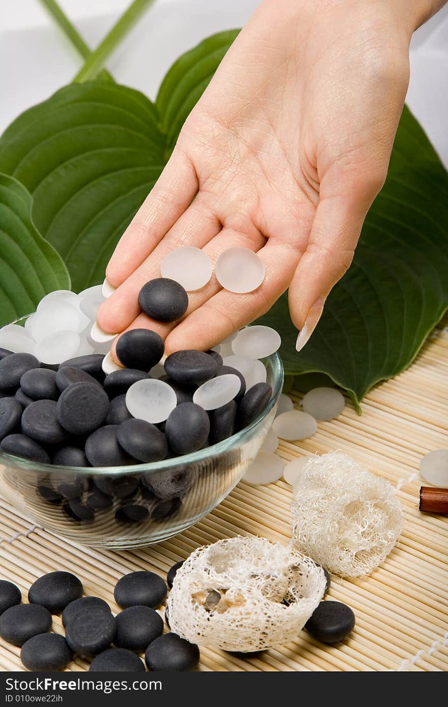 White And Black Small Stones Lay In A Hand