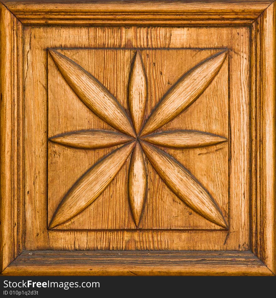 Carved wooden floral detail with a frame. Carved wooden floral detail with a frame