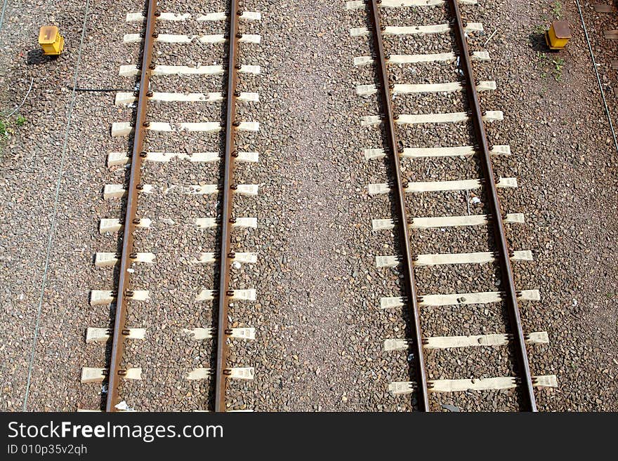 Two railroad tracks with sand in background