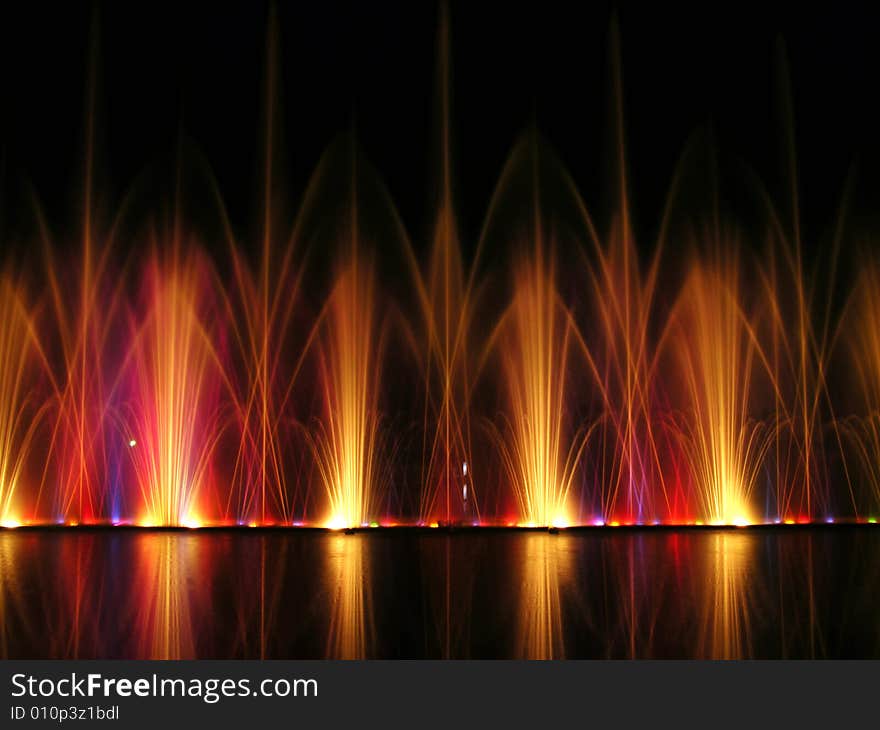 The wall of colourful fountains at night in Florida. The wall of colourful fountains at night in Florida.