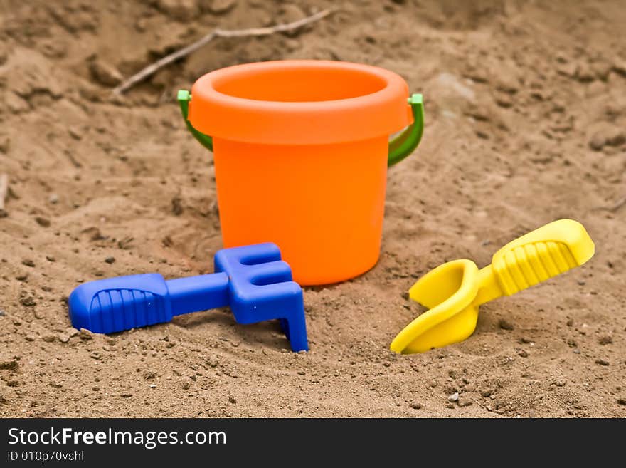 Plastic children toys lying in the sand. Plastic children toys lying in the sand