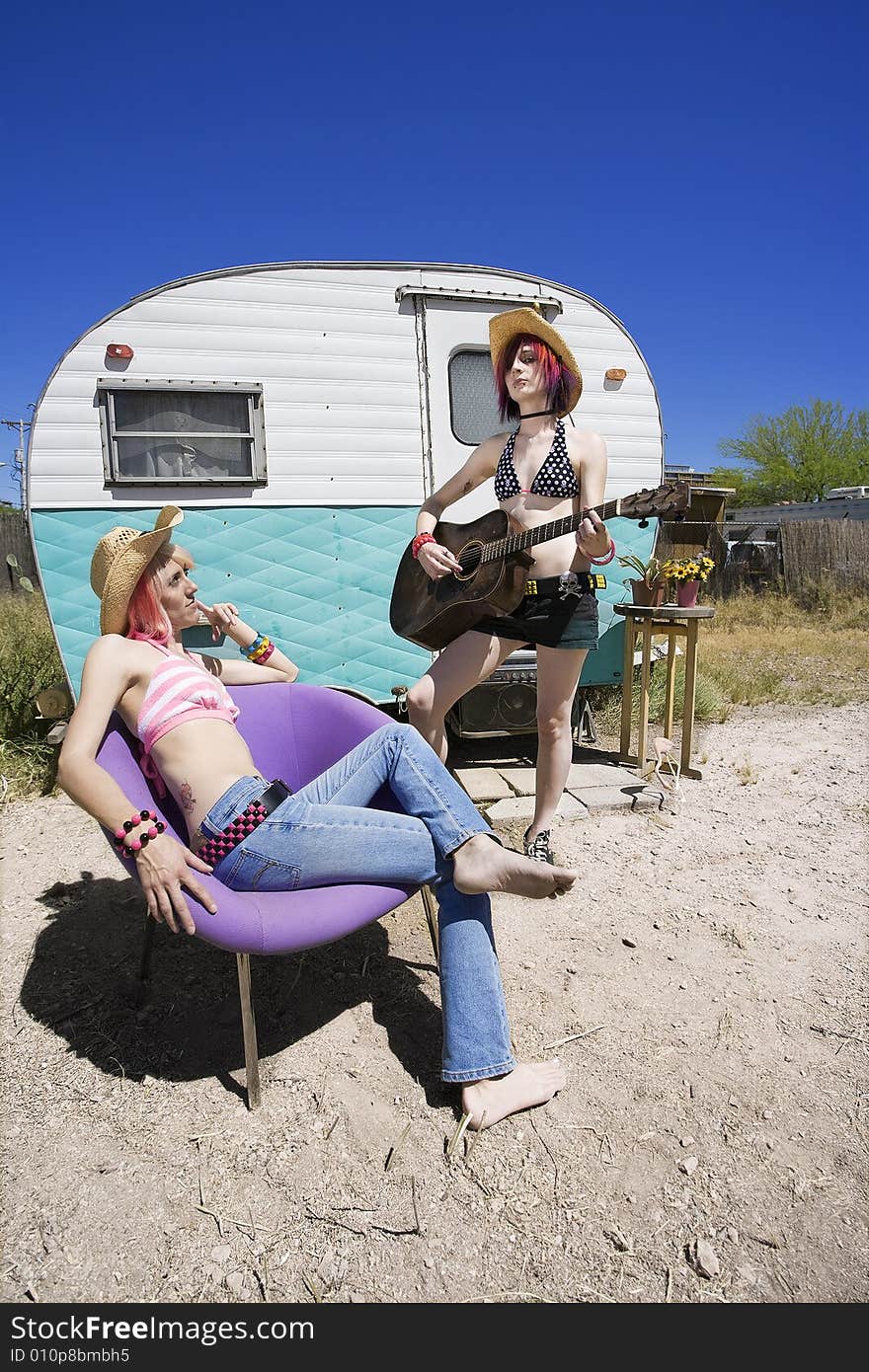 Two Young Punk Women in Front of a Trailer. Two Young Punk Women in Front of a Trailer