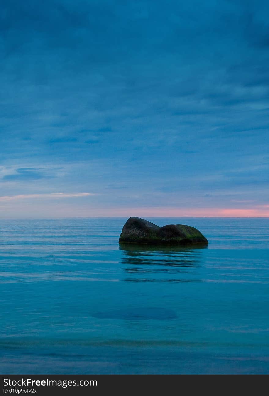 Two stones in the sea at night. Two stones in the sea at night.