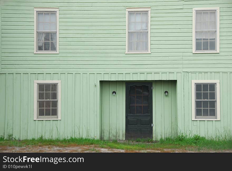 The front of an old green house. The front of an old green house.