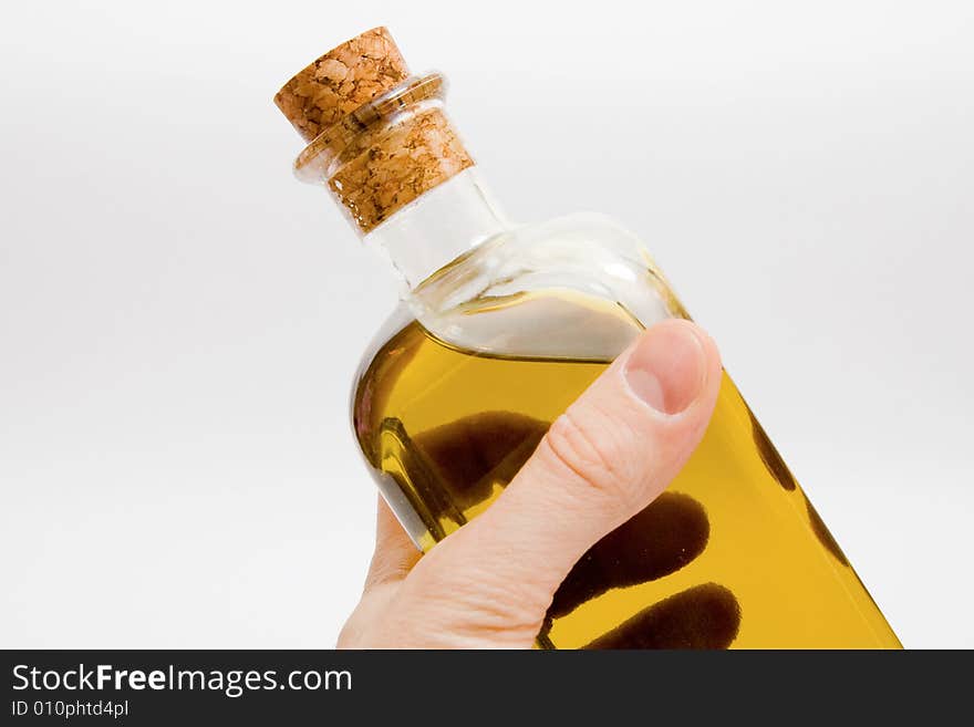 Man keeps a bottle of olive oil. closed-up. Man keeps a bottle of olive oil. closed-up