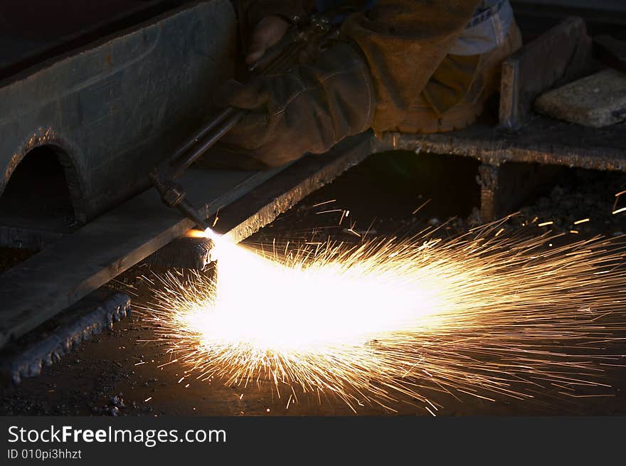 A shipyard steel worker burning steel. A shipyard steel worker burning steel