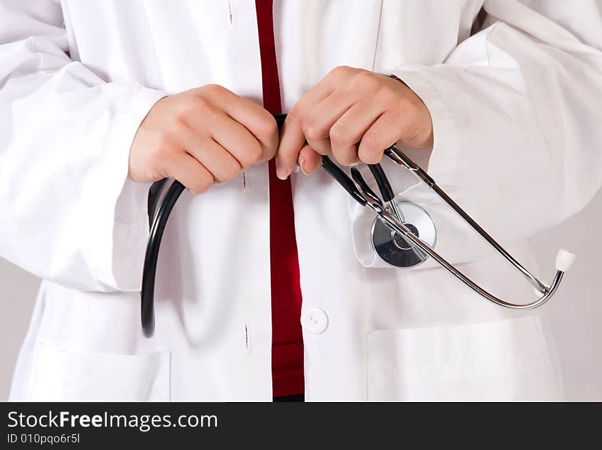 Health care worker in a scrubsuit holding a stethoscope.