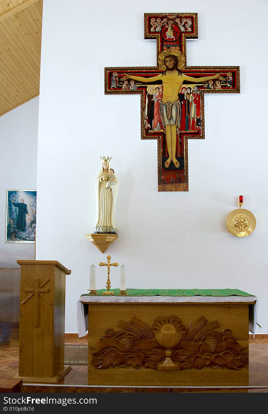 Altar in a little church with a cross on a wall. Altar in a little church with a cross on a wall