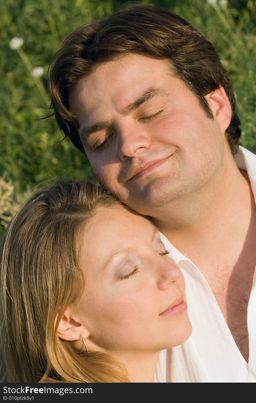 Portrait of happy couple with closed eyes