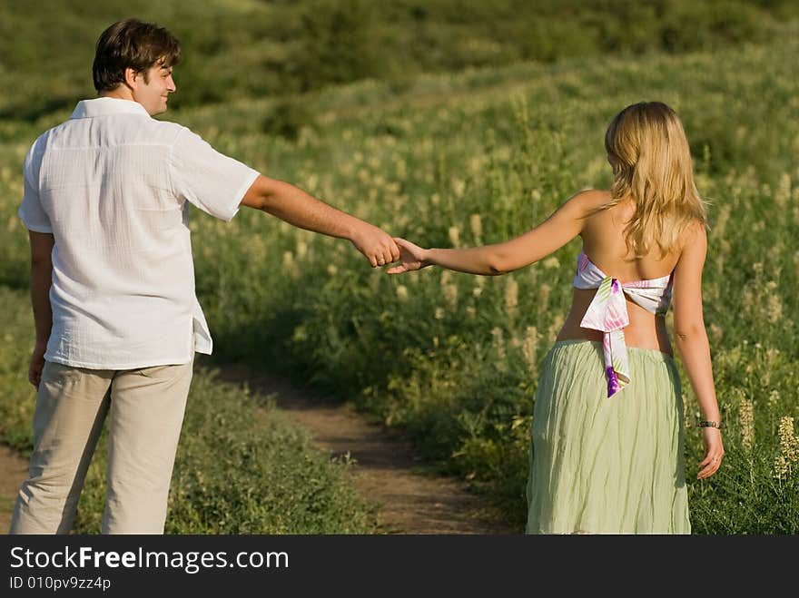 Young married couple on the walk, woman is pregnant