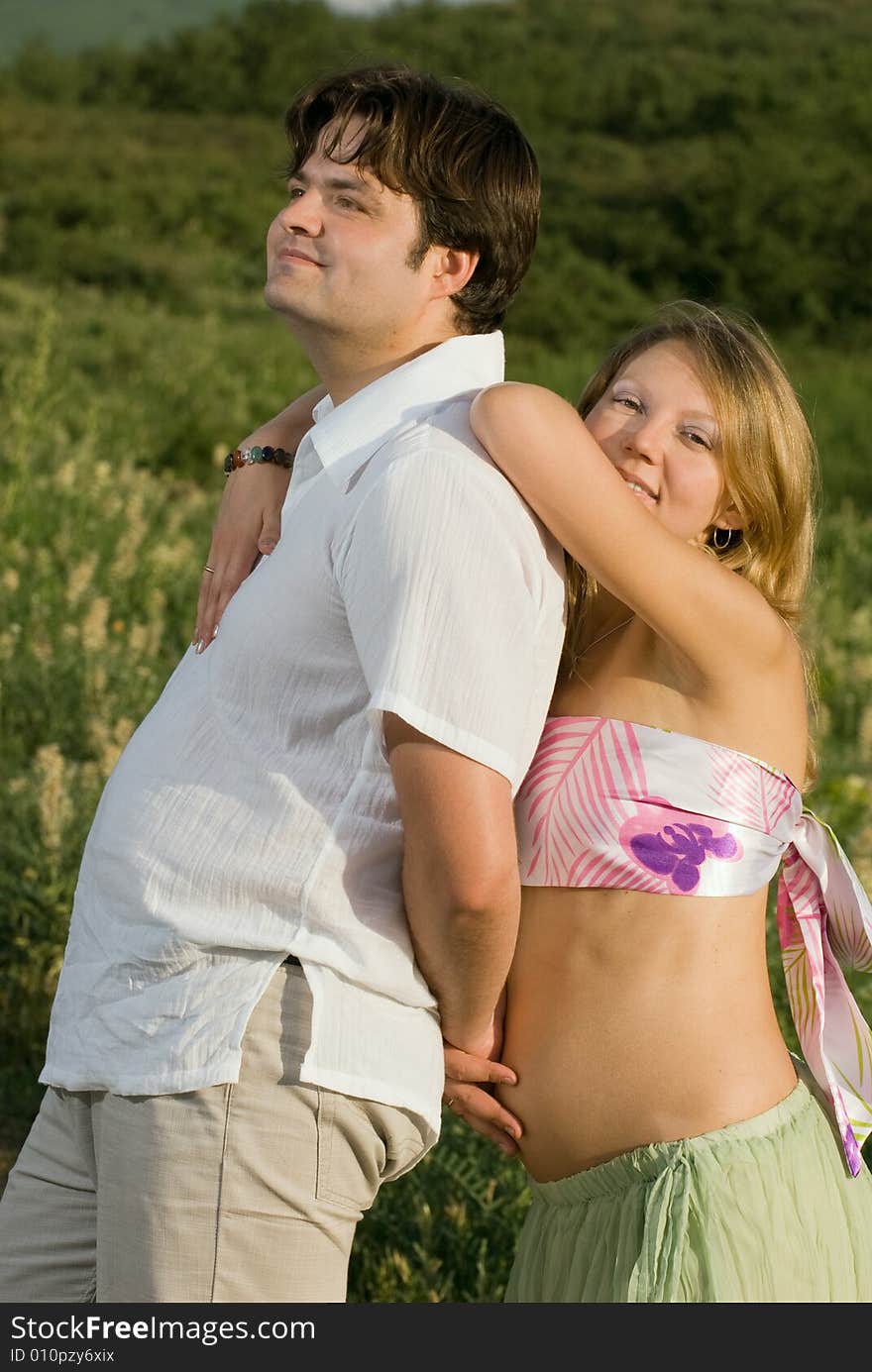 Happy married couple outdoors, woman is pregnant. Happy married couple outdoors, woman is pregnant