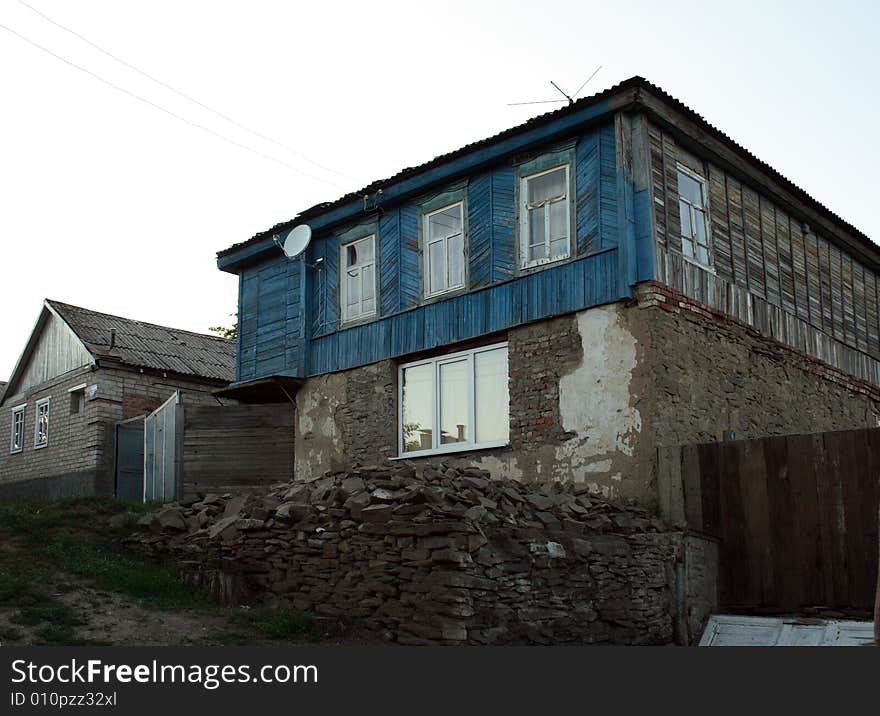 The old house with new windows and satellite антеной as a symbol of arrival of new time in a traditional way of life. The old house with new windows and satellite антеной as a symbol of arrival of new time in a traditional way of life