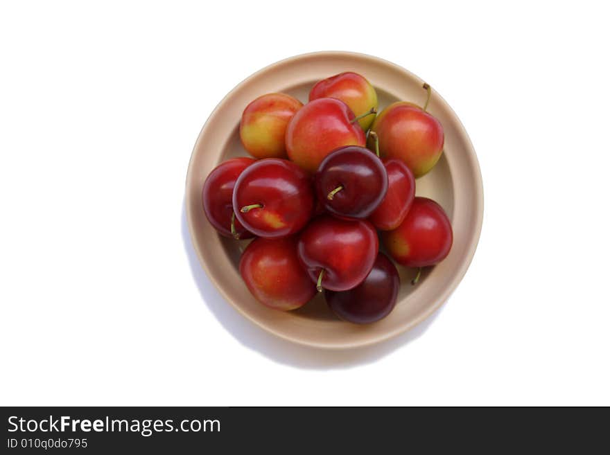 Plums on plate isolated on white bacground