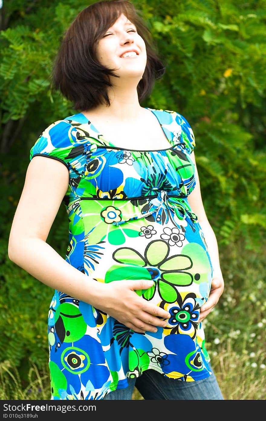 Pregnant woman relaxing on grass. Pregnant woman relaxing on grass