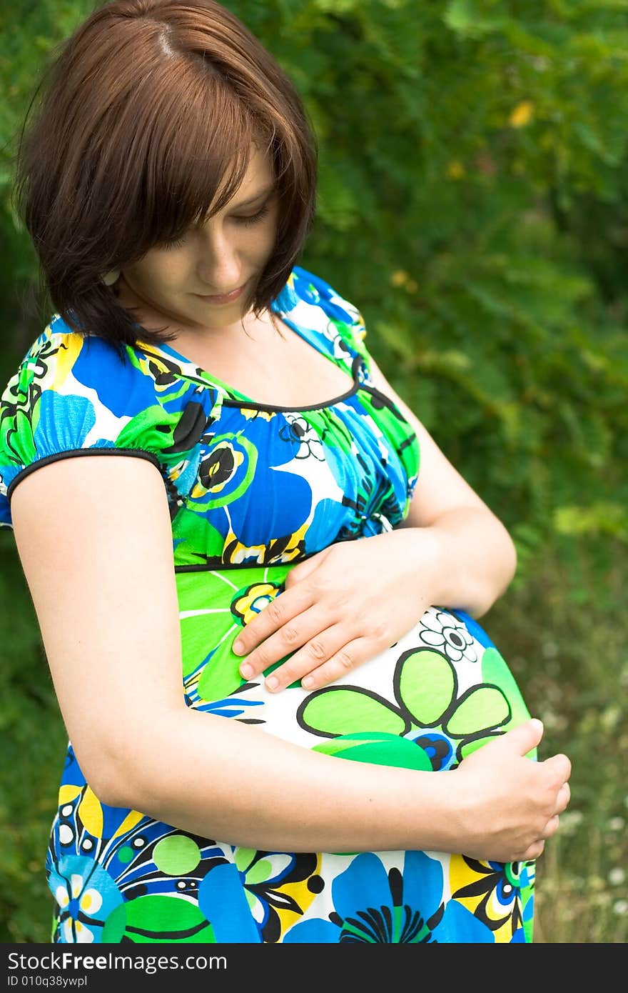 Pregnant woman relaxing on grass. Pregnant woman relaxing on grass