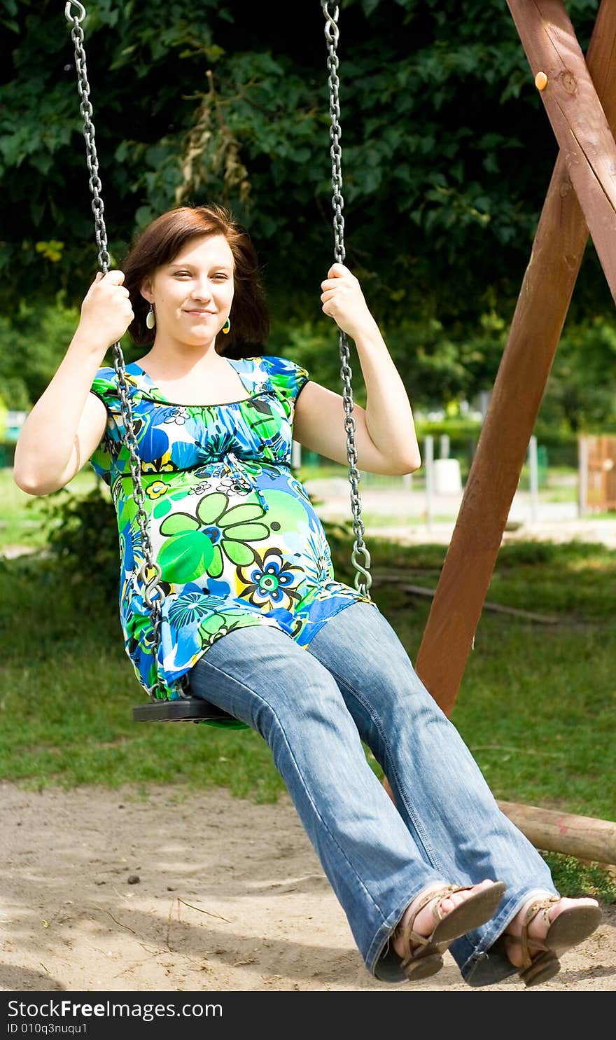 Pregnant woman on swing