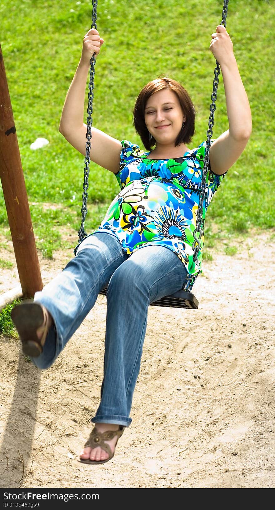 Pregnant woman on swing