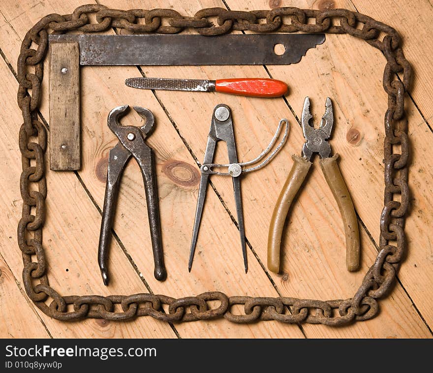 Old tools lay on wooden to a floor.