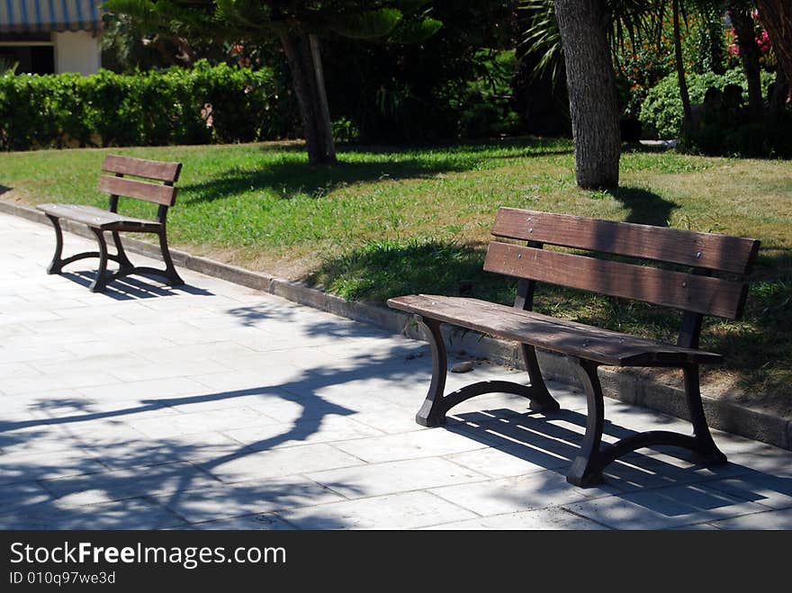 Benches on a boardwalk near a park