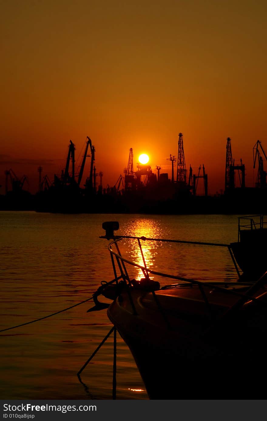 Sunset at the Black Sea coast in Bulgaria. The industrial port of Varna. Sunset at the Black Sea coast in Bulgaria. The industrial port of Varna.