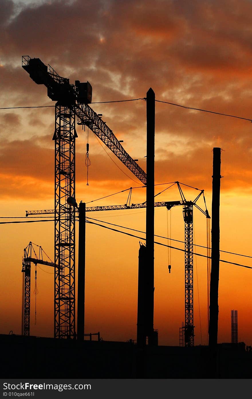 The tower crane on a background of the evening sky