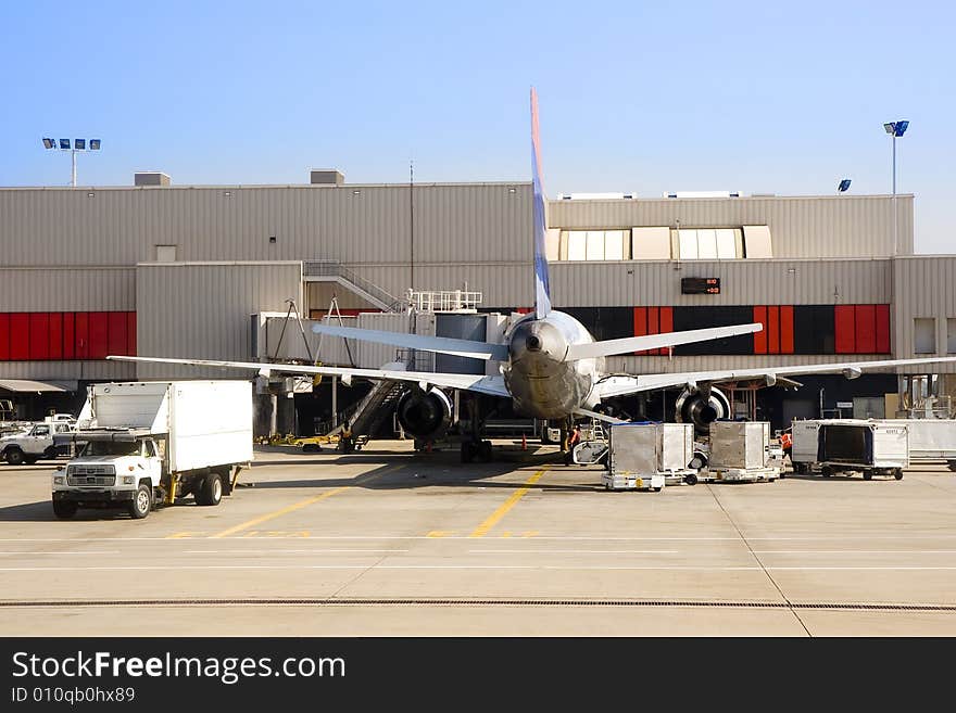 A large airliner waiting at the gate for passengers. A large airliner waiting at the gate for passengers