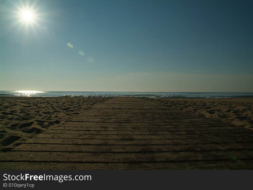 Wooden path on beach towards ocean. Wooden path on beach towards ocean