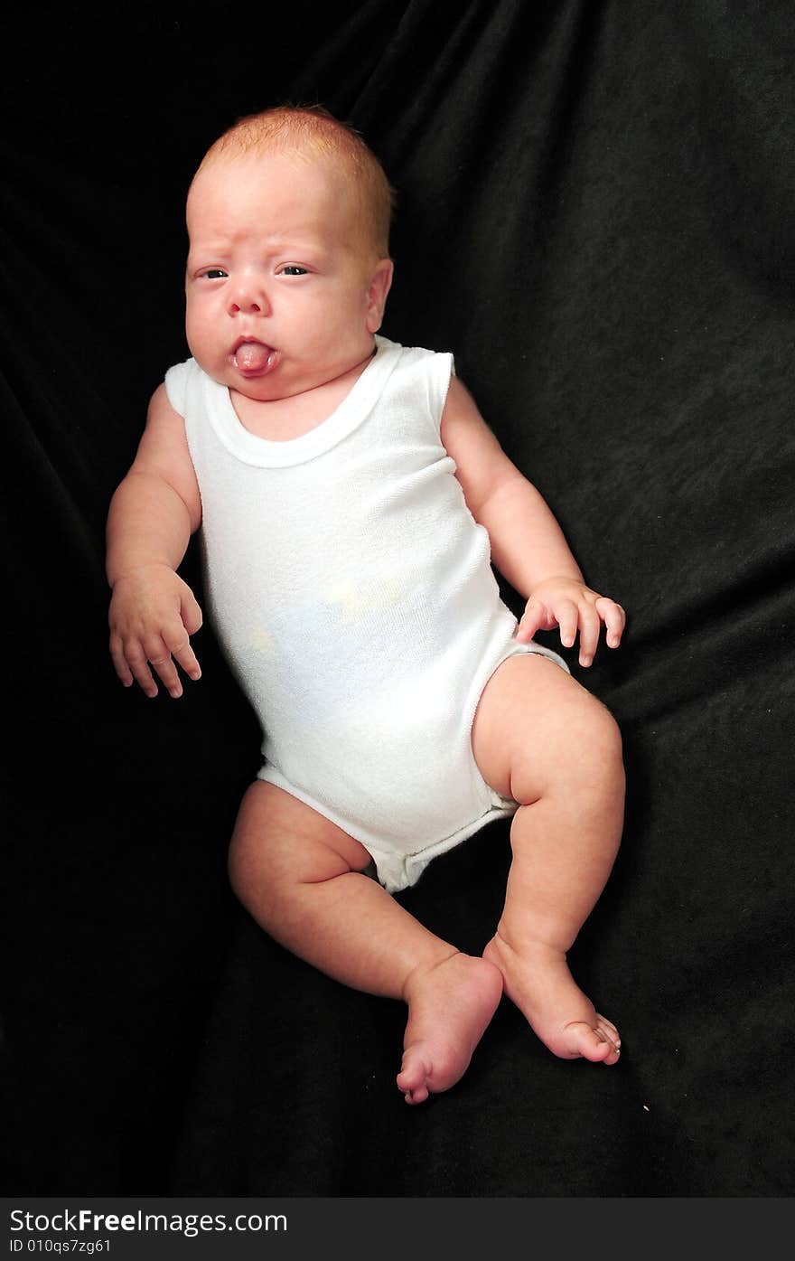 Baby boy isolated over black