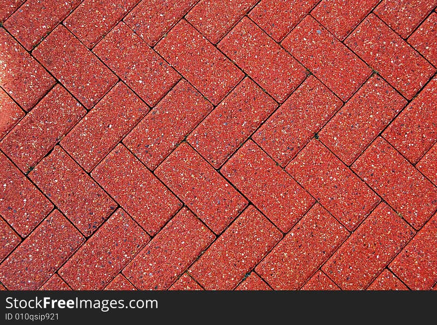 Red stones pavement with a patterned design. Red stones pavement with a patterned design