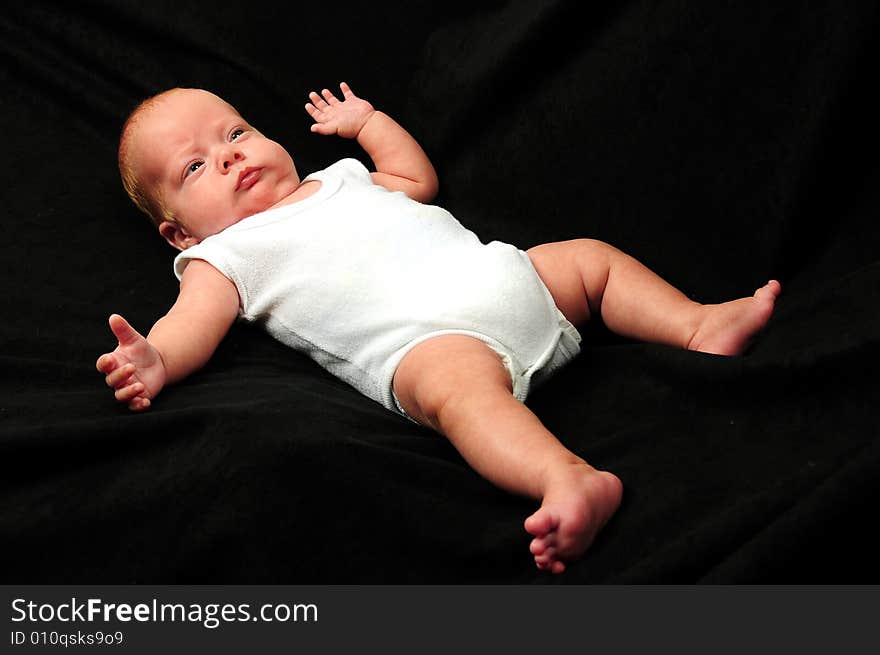 Baby boy isolated over black