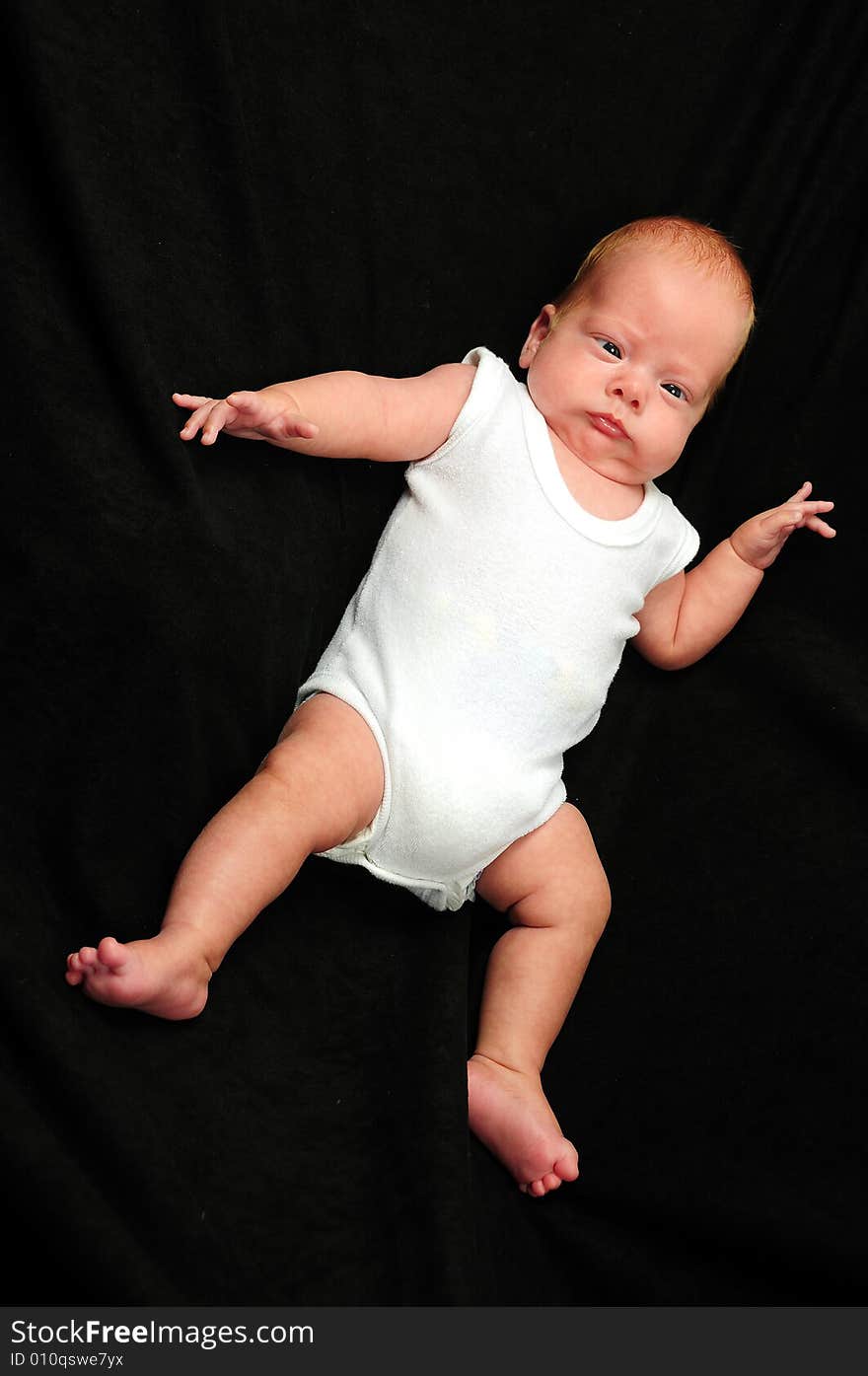 Baby boy isolated over black