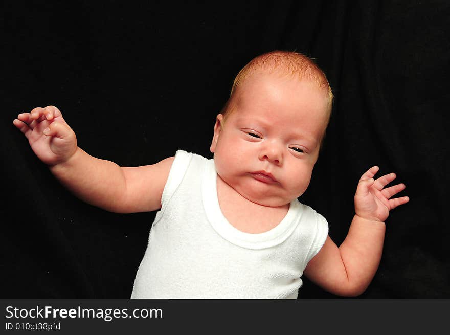 Baby boy isolated over black