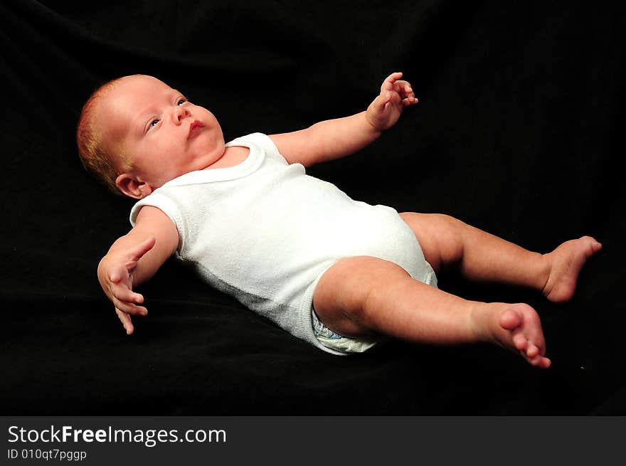 Baby boy isolated over black