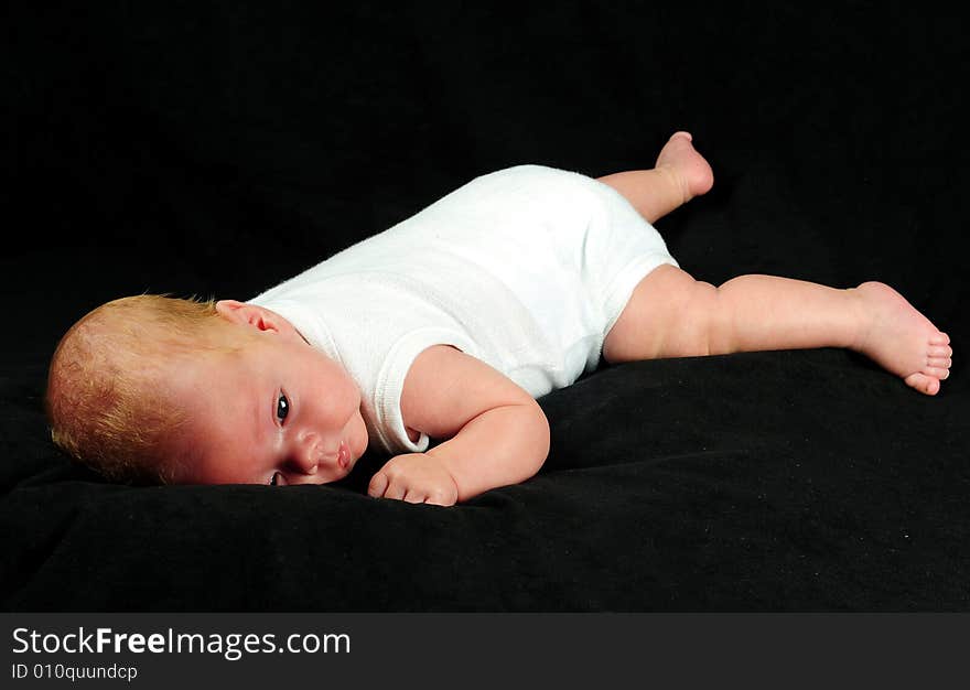 Baby boy isolated over black