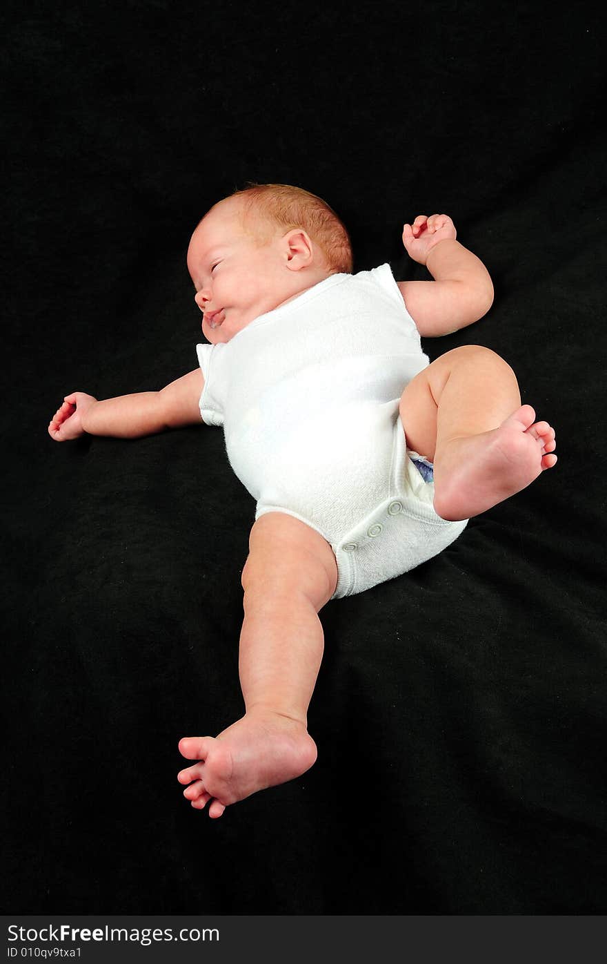 Baby boy isolated over black