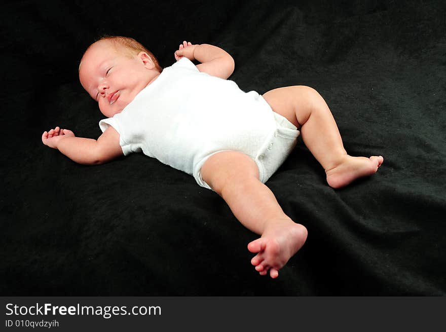 Baby boy isolated over black