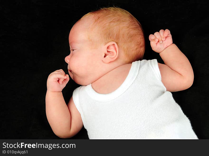 Baby boy isolated over black