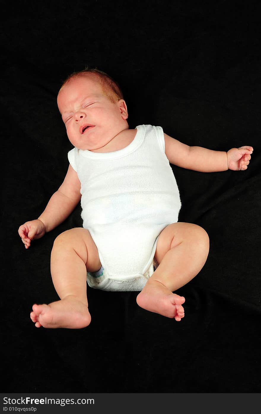 Baby boy isolated over black