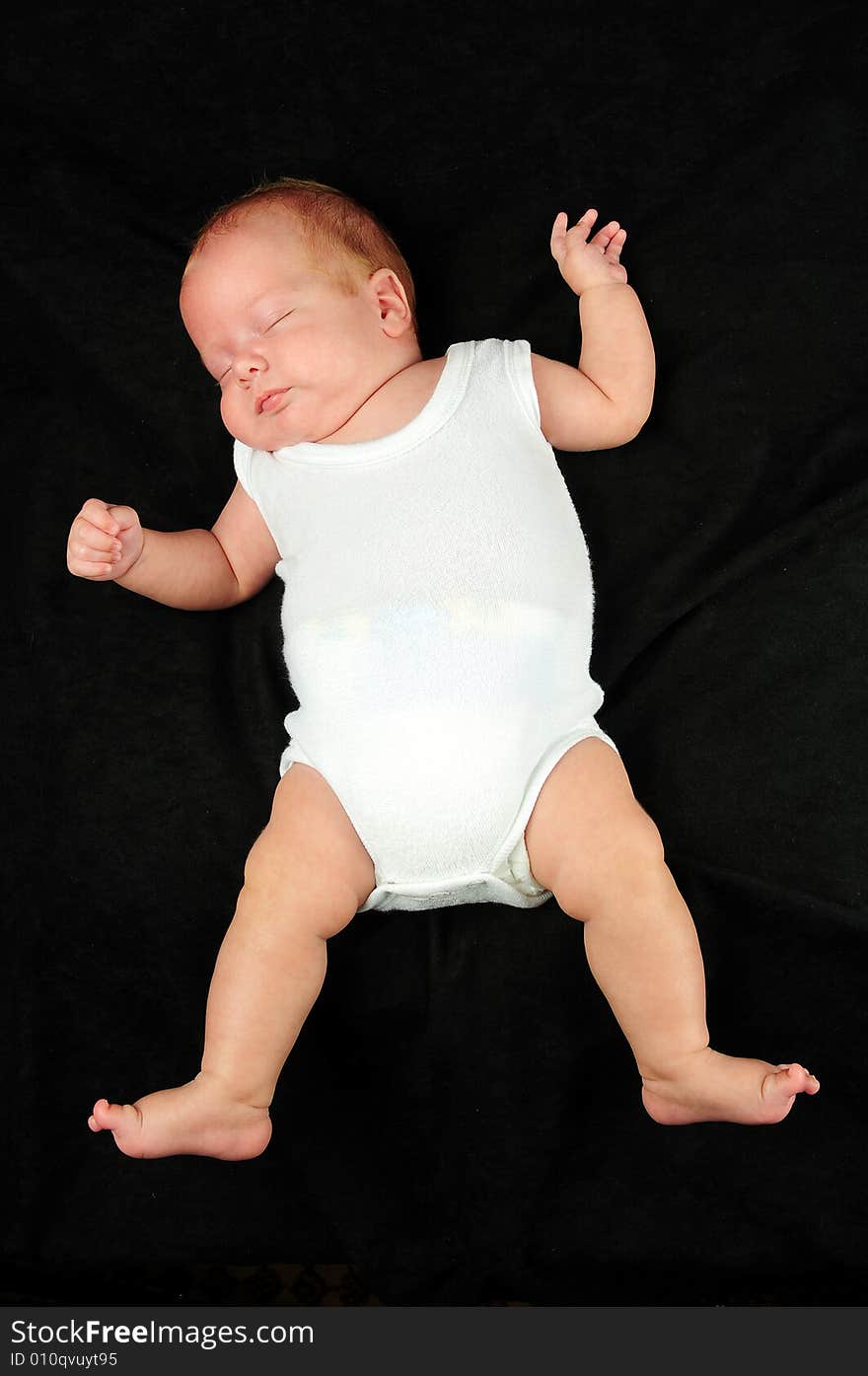 Baby boy isolated over black