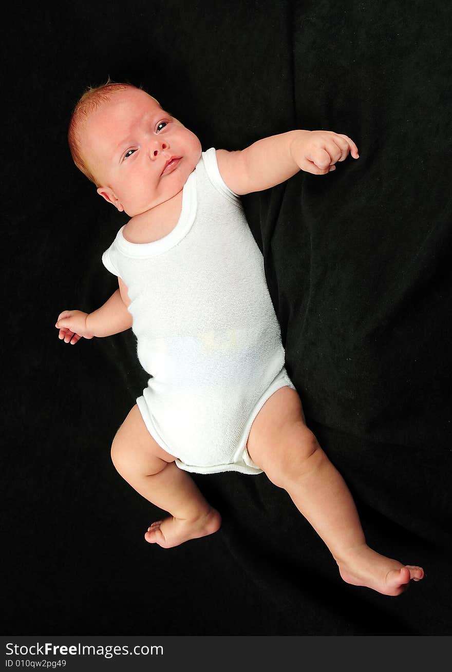 Baby boy isolated over black